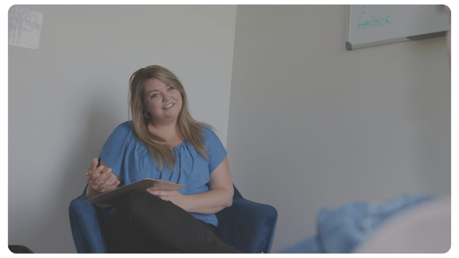 Breanne-Lyng-smiling-wearing-blue-shirt-sitting-down1a