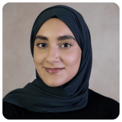 Amani-Abdella-smiling-wearing-green-scarf-and-black-sweater1