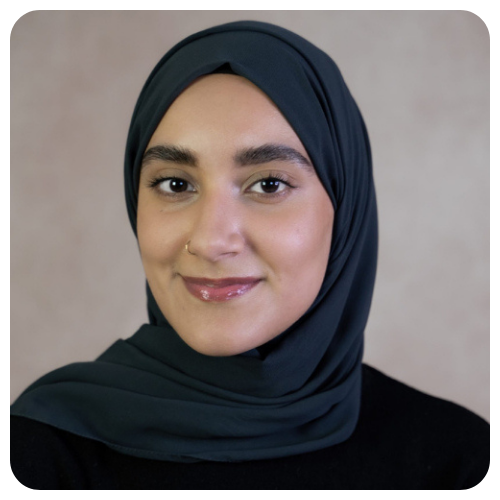 Amani-Abdella-smiling-wearing-green-scarf-and-black-sweater1