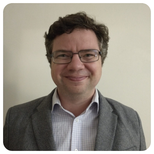 Spencer-McBride-smiling-gray-jacket-with-white-black-lined-shirt1