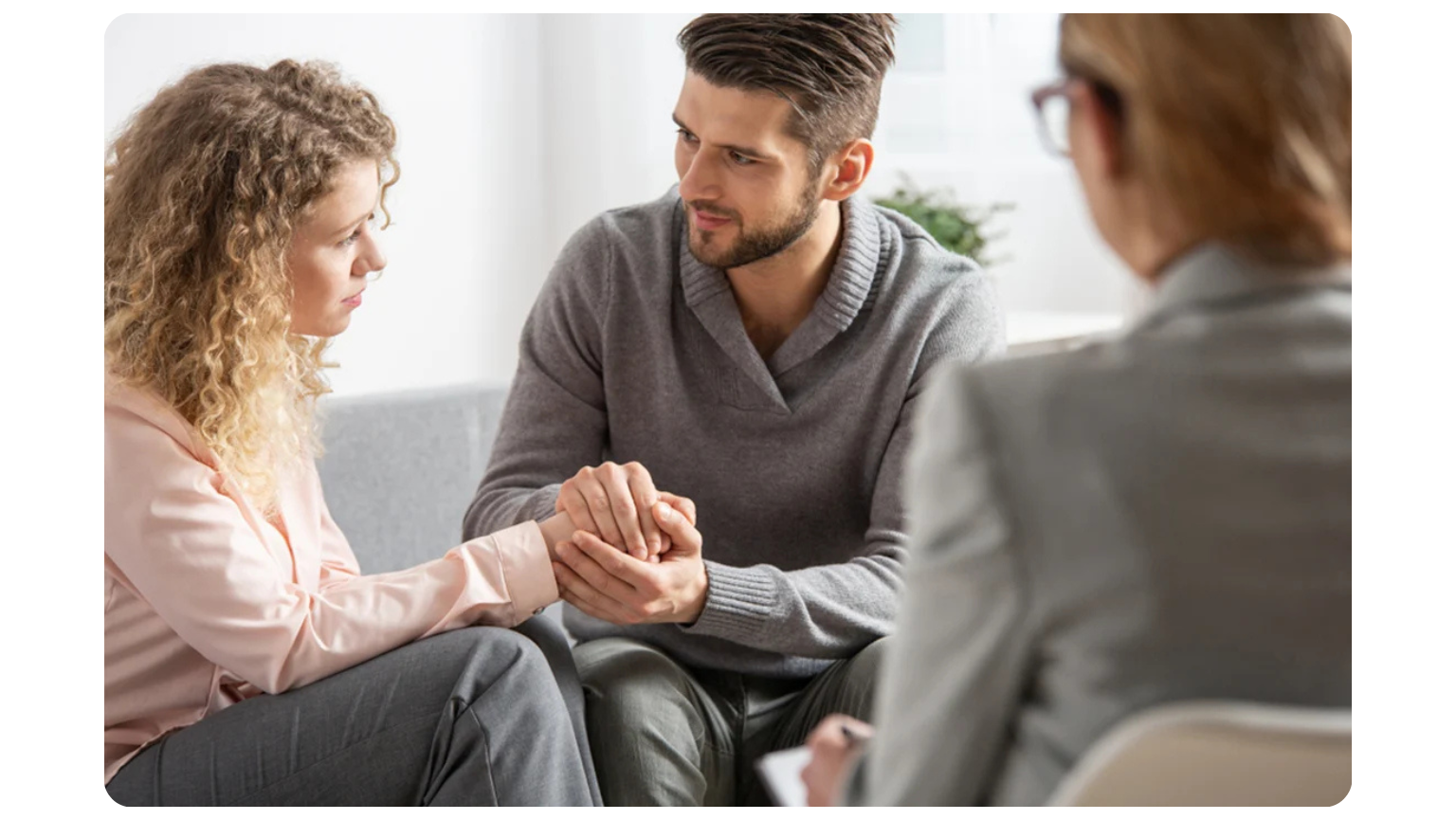 Couples-Therapy-man-and-woman-holding-hands-sitting-with-therapist1