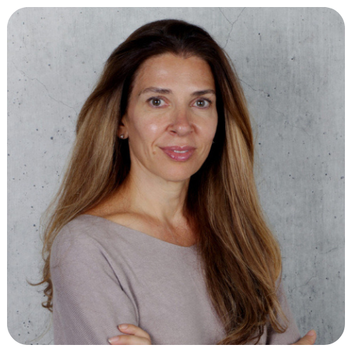 Helen Elena Calligeris is smiling in a professional portrait, wearing a gray sweater.