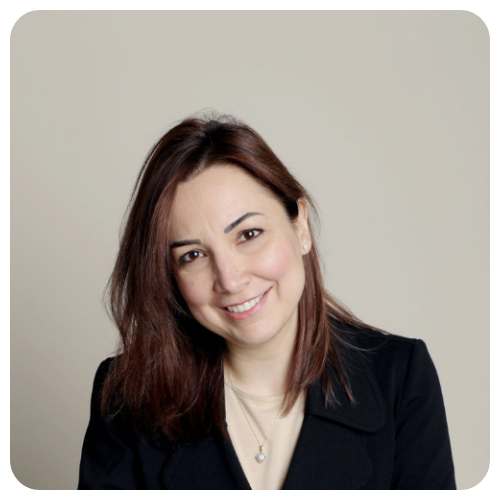 Lina Jarkas is smiling, wearing a black jacket over a white shirt.